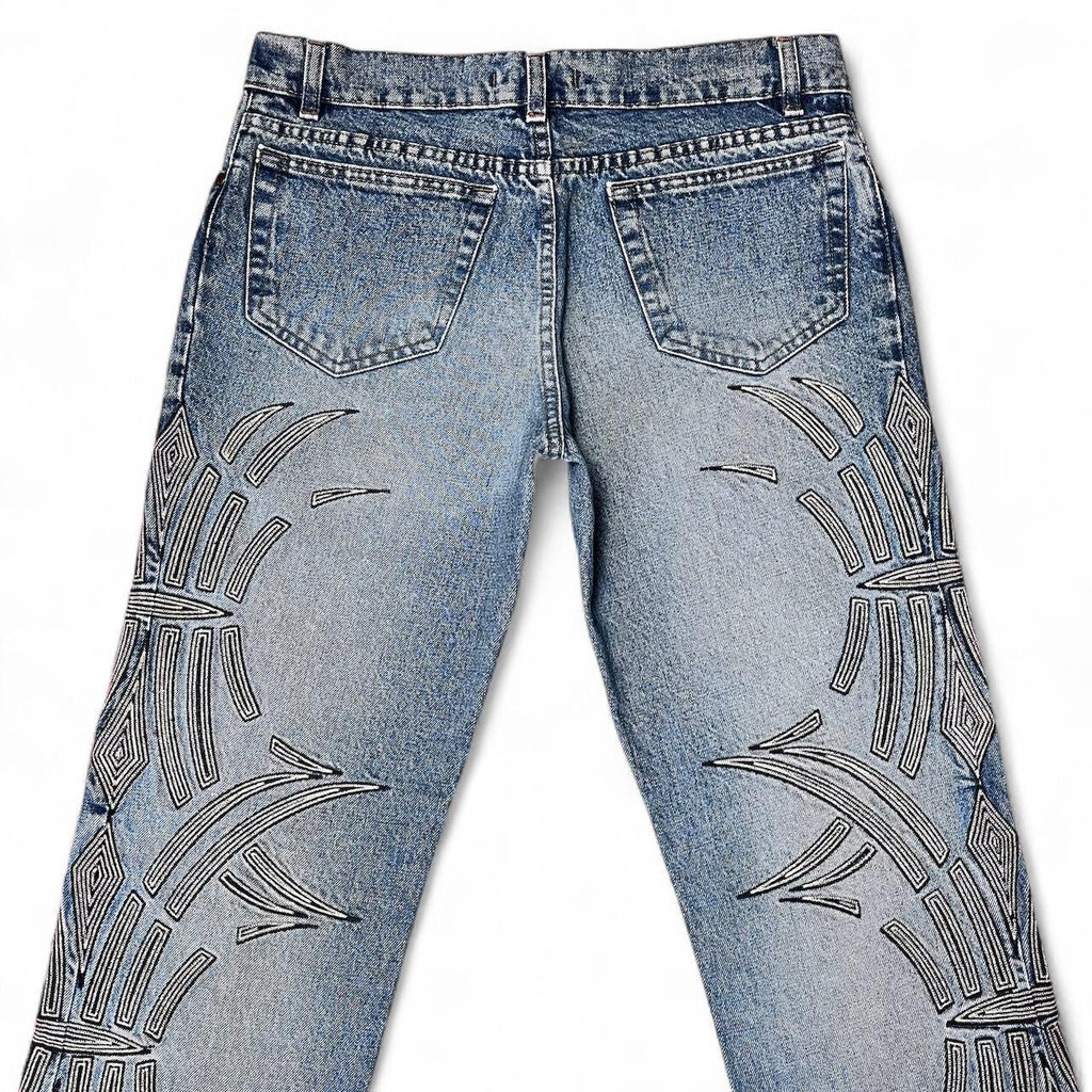 Curved tattoo embroidery blue jeans