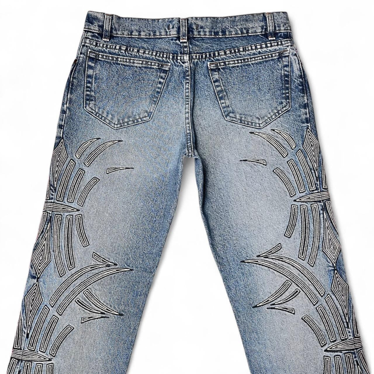 Curved tattoo embroidery blue jeans