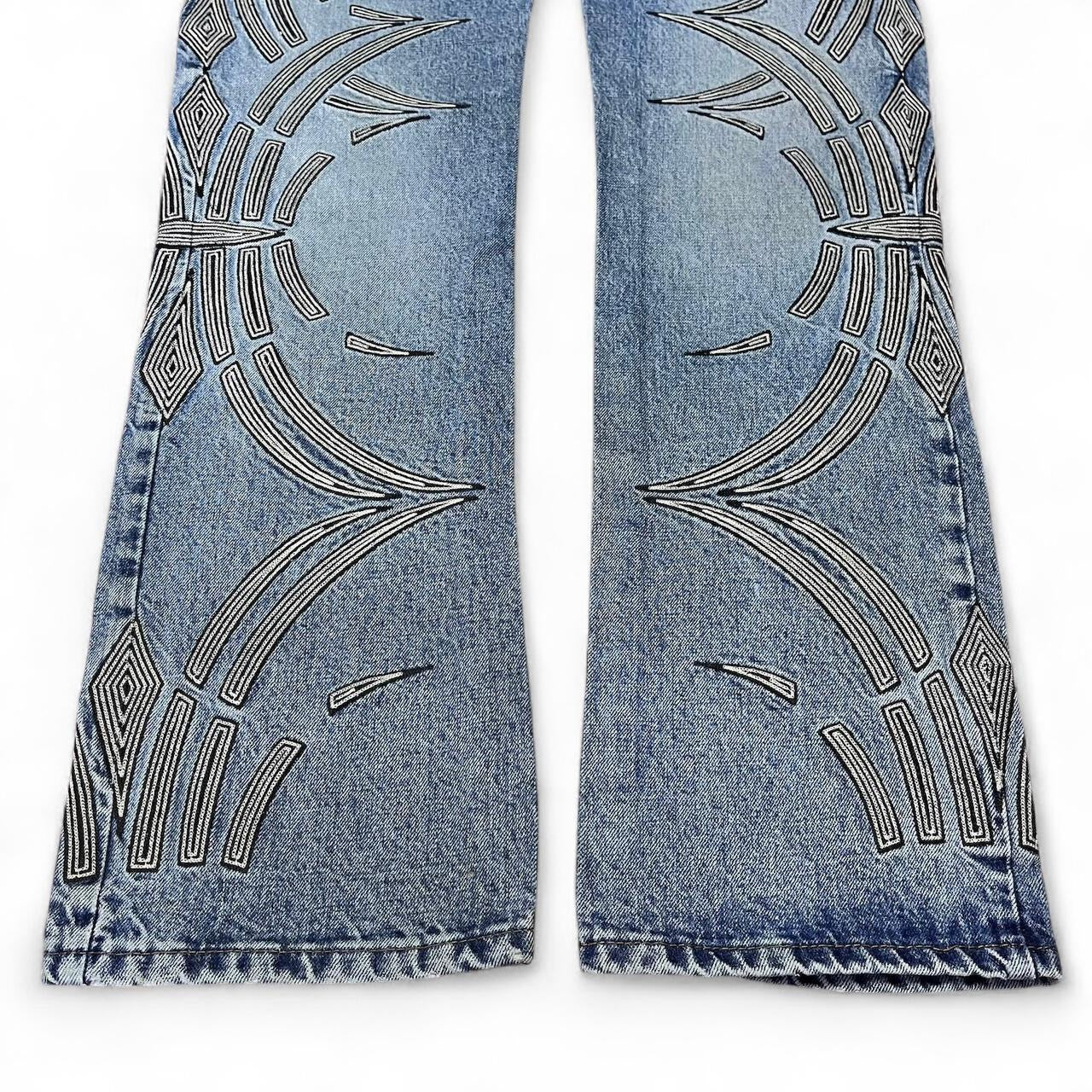 Curved tattoo embroidery blue jeans