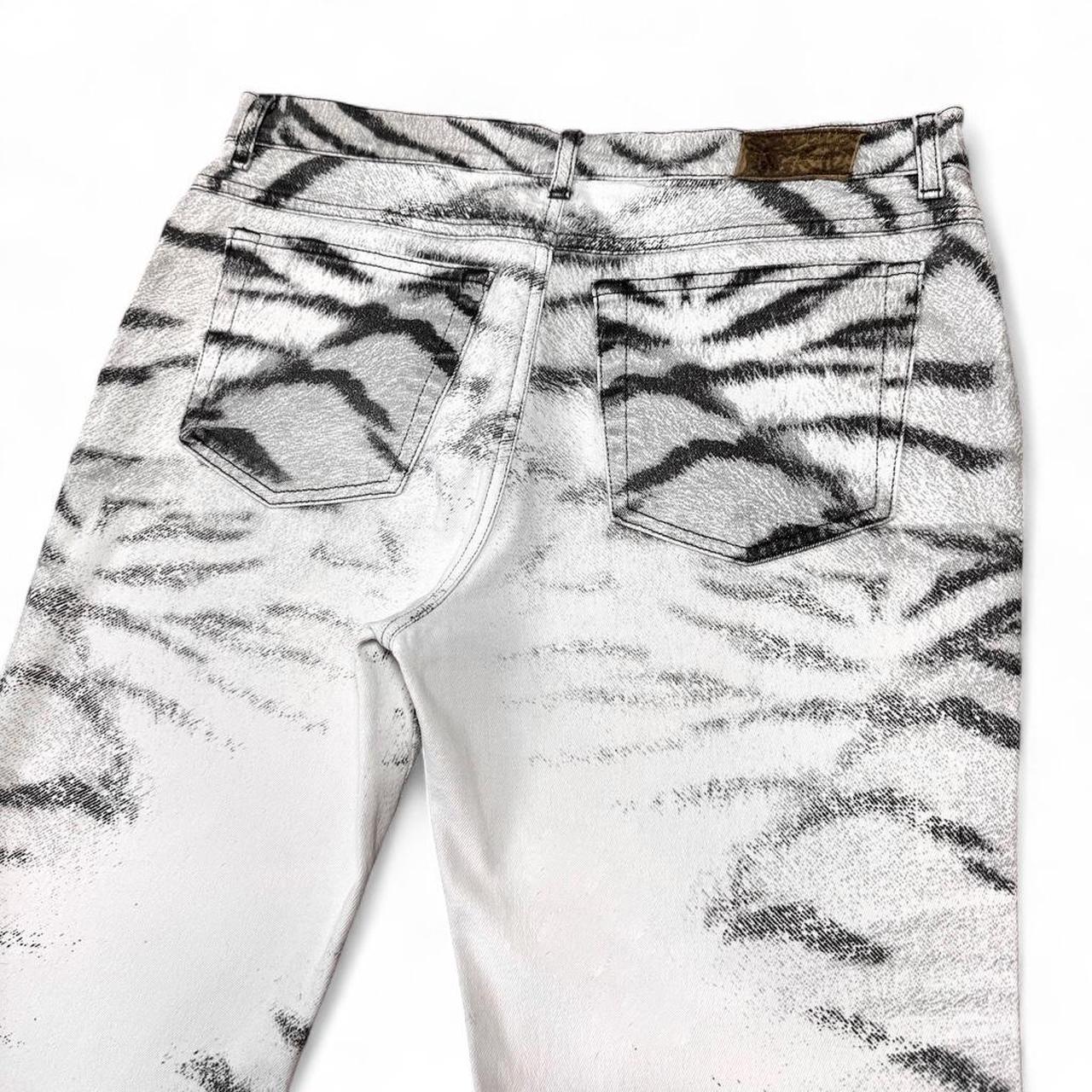 White jeans with tiger print on a white background