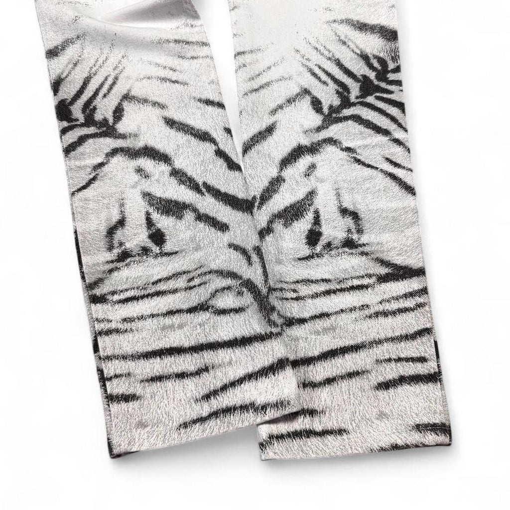 Two pairs of socks with tiger stripe pattern on a white background