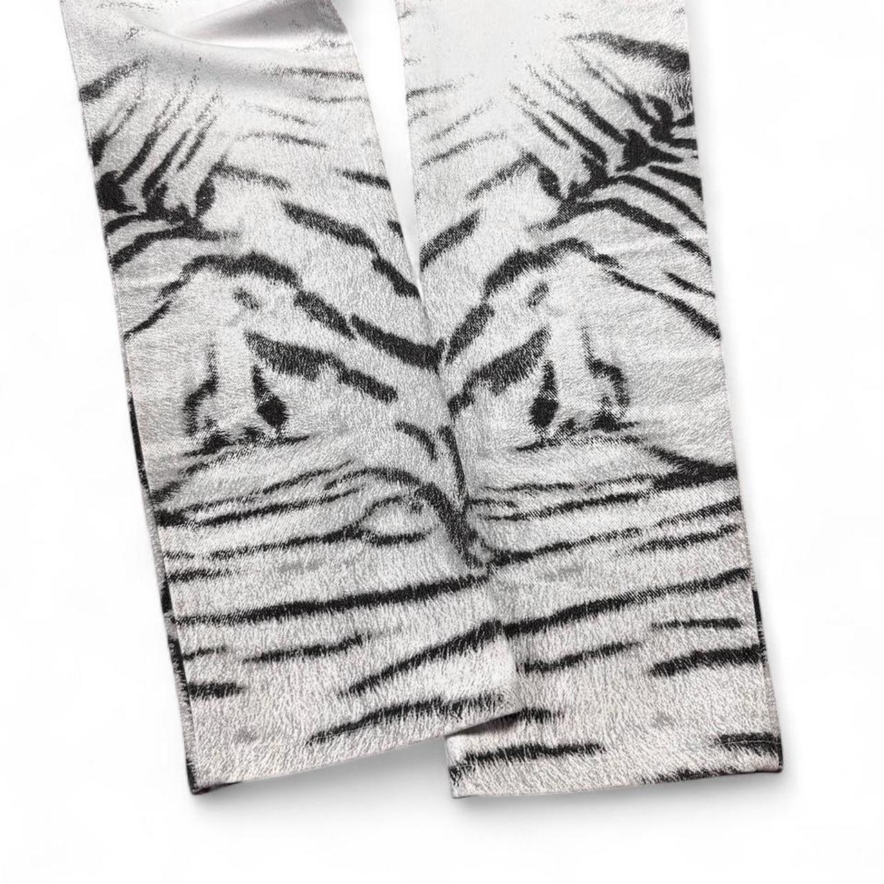Two pairs of socks with tiger stripe pattern on a white background